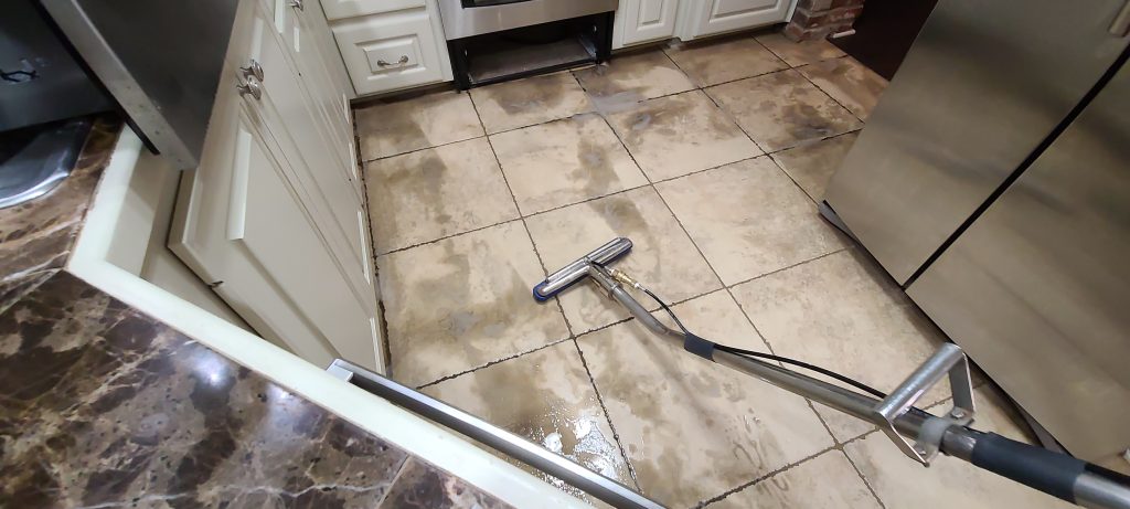 Tile and grout cleaning in progress in a Hattiesburg kitchen - Hydra Clean