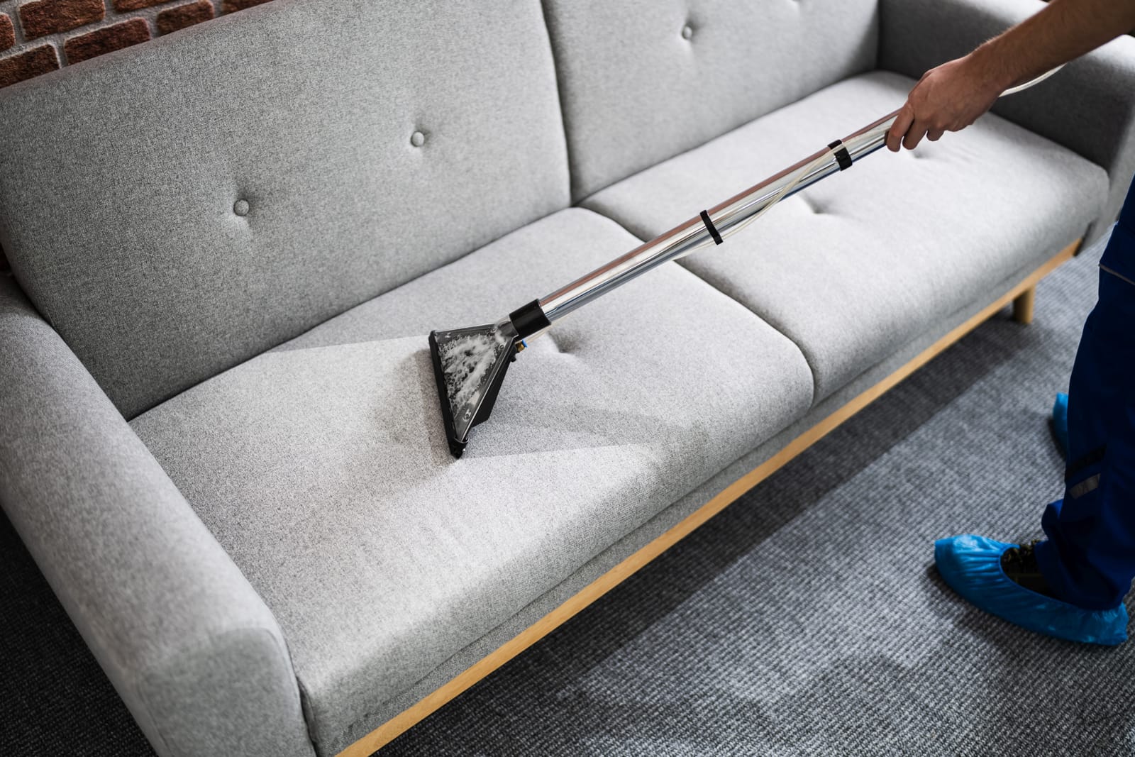 Professional upholstery extraction cleaning on a fabric sofa